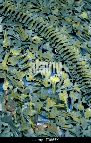 Close up of keys piles with shallow depth of field. Dramatic image with patterns. Gold and blue tinted vertical photograph Stock Photo