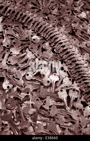 Close up of keys piles with shallow depth of field. Dramatic image with patterns. Golden toned vertical photograph Stock Photo