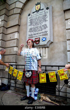 Scottish football fans, known as the Tartan Army, ascend on the William Wallace memorial in London ahead of their friendly game Stock Photo