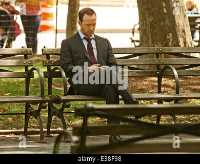 'Blue Bloods' star Donnie Wahlberg seen on his mobile sitting in the park  Featuring: Donnie Wahlberg Where: New York, NY, Unite Stock Photo