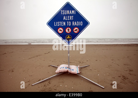 Tsunami warning sign on a beach in Nelson, New Zealand Stock Photo