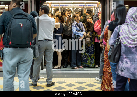 Commuters wait on a train at a RapidKL LRT station in Kuala Lumpur, Malaysia Stock Photo