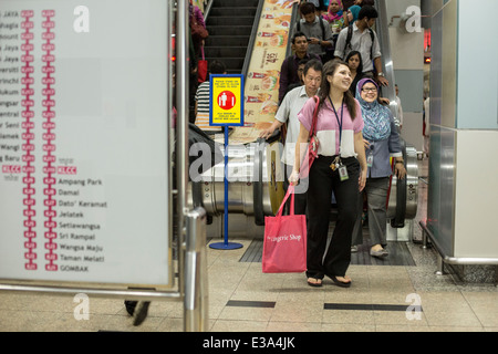 Commuters arrive at the platform level of a RapidKL LRT station in Kuala Lumpur, Malaysia Stock Photo