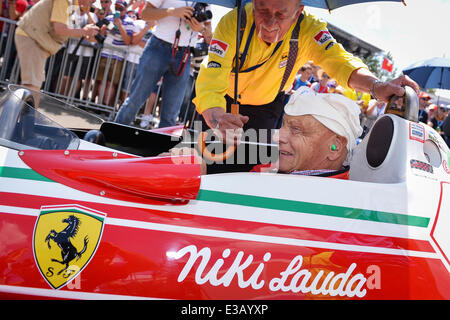 Spielberg, Austria. 22nd June, 2014. The non-executive chairman of Mercedes AMG, former Austrian Formula One driver Niki Lauda, sits in his 1976 Ferrari 312T2 next to his mechanic Ermanno Cuoghi from old times prior to the start of the 2014 Formula One Grand Prix of Austria at the Red Bull Ring race track in Spielberg, Austria, 22 June 2014. Photo: David Ebener/dpa/Alamy Live News Stock Photo