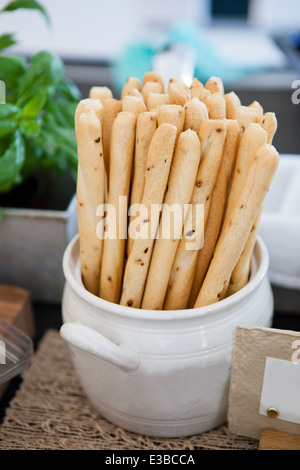 Closeup of bunch of long small bread sticks in bowl Stock Photo