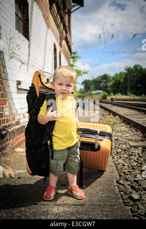 little boy waiting for the train on a railway station Stock Photo