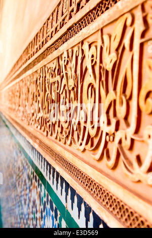 Detail of the fine carving and tile-work at the Ben Youssef Medersa in Marrakesh, Morocco, North Africa. Stock Photo