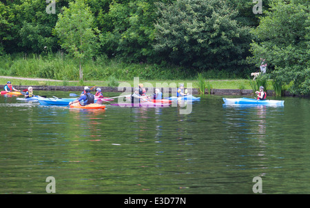 Children and instructors canoeing/kayaking  on the lake in Yarrow Valley Country Park, Coppull in Lancashire, UK. Stock Photo