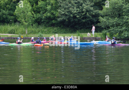 Children and instructors canoeing/kayaking  on the lake in Yarrow Valley Country Park, Coppull in Lancashire, UK. Stock Photo