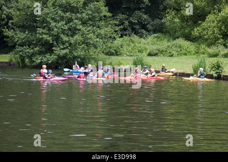 Children and instructors canoeing/kayaking  on the lake in Yarrow Valley Country Park, Coppull in Lancashire, UK. Stock Photo