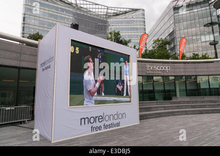 The Scoop, More London, London, UK, 23 June 2014 - on the opening day of Wimbledon 2014, fans gather to watch live tennis on a giant LCD screen as part of the More London free festival.  On screen, on Centre Court, 2013 men's champion, Andy Murray (GB),  begins the defence of his title with a victory over David Goffin (Belgium), 6-1 6-4 7-5. Credit:  Stephen Chung/Alamy Live News Stock Photo