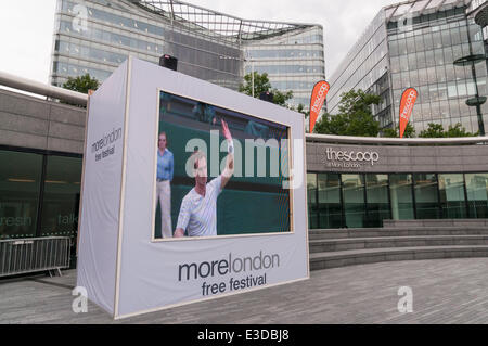The Scoop, More London, London, UK, 23 June 2014 - on the opening day of Wimbledon 2014, fans gather to watch live tennis on a giant LCD screen as part of the More London free festival.  On screen, on Centre Court, 2013 men's champion, Andy Murray (GB),  begins the defence of his title with a victory over David Goffin (Belgium), 6-1 6-4 7-5.  © Stephen Chung/Alamy Live News Credit:  Stephen Chung/Alamy Live News Stock Photo
