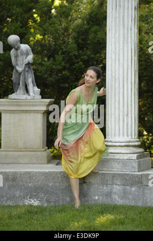Old Westbury, New York, USA. 21st June, 2014. A dancer appears at the Colonnade when Lori Belilove & The Isadora Duncan Dance Company starts to dance throughout the gardens, at the Long Island Gold Coast estate of Old Westbury Gardens on the first day of summer, the summer solstice. © Ann Parry/ZUMA Wire/ZUMAPRESS.com/Alamy Live News Stock Photo
