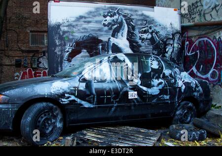 British graffiti artist Banksy gets political in his latest work in Manhattan's Lower East Side. The street artist revealed an intricate installation on Ludlow Street. Viewers said they were alarmed to hear the accompanying audio, from a 2007 raid in Baghdad. This installation is much more political than Banksy’s previous works, featuring spray-painted targets, armed soldiers and horses in night vision goggles.  Featuring: Atmosphere Where: New York City, NY, United States When: 12 Oct 2013 Stock Photo