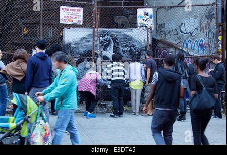 British graffiti artist Banksy gets political in his latest work in Manhattan's Lower East Side. The street artist revealed an intricate installation on Ludlow Street. Viewers said they were alarmed to hear the accompanying audio, from a 2007 raid in Baghdad. This installation is much more political than Banksy’s previous works, featuring spray-painted targets, armed soldiers and horses in night vision goggles.  Featuring: Atmosphere Where: New York City, NY, United States When: 12 Oct 2013 Stock Photo