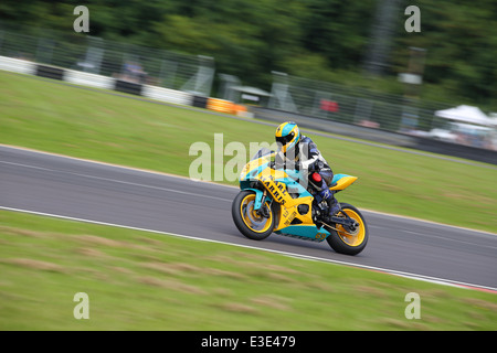 Motorcycles racing around Castle Combe Circuit at their Grand National Motorcycle Race Meeting weekend. Stock Photo