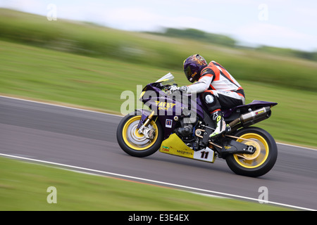 Motorcycles racing around Castle Combe Circuit at their Grand National Motorcycle Race Meeting weekend. Stock Photo