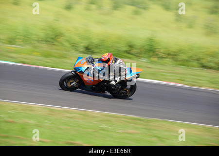 Motorcycles racing around Castle Combe Circuit at their Grand National Motorcycle Race Meeting weekend. Stock Photo