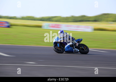 Motorcycles racing around Castle Combe Circuit at their Grand National Motorcycle Race Meeting weekend. Stock Photo