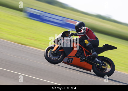 Motorcycles racing around Castle Combe Circuit at their Grand National Motorcycle Race Meeting weekend. Stock Photo