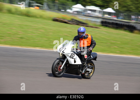 Motorcycles racing around Castle Combe Circuit at their Grand National Motorcycle Race Meeting weekend. Stock Photo