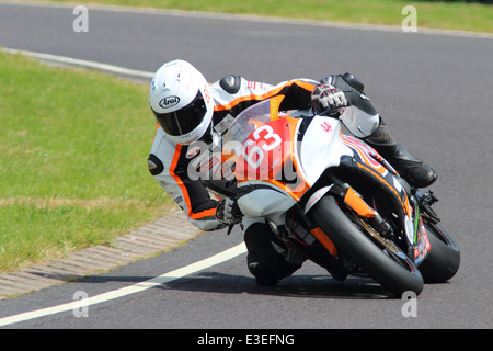 Motorcycles racing around Castle Combe Circuit at their Grand National Motorcycle Race Meeting weekend. Stock Photo