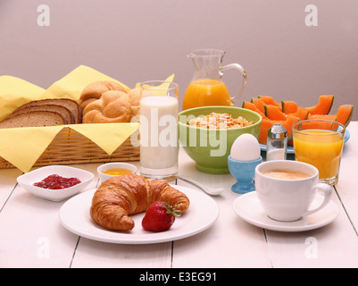 Healthy breakfast with croissants, cup of coffee and fruits, close up Stock Photo