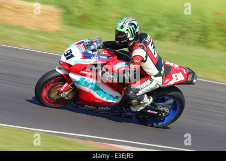 Motorcycles racing around Castle Combe Circuit at their Grand National Motorcycle Race Meeting weekend. Stock Photo