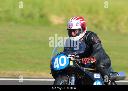 Motorcycles racing around Castle Combe Circuit at their Grand National Motorcycle Race Meeting weekend. Stock Photo