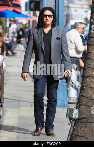 Gene Simmons seen leaving Panini Cafe in Beverly Hills. He goes to his car to show the photographers an award he was recently given, The Charles Durning Award. Gene then poses for a picture with a young fan and gives the fan his sunglasses for the shot. Stock Photo