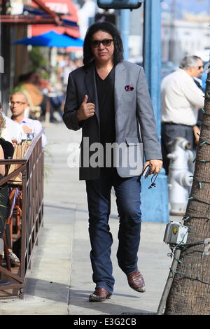 Gene Simmons seen leaving Panini Cafe in Beverly Hills. He goes to his car to show the photographers an award he was recently given, The Charles Durning Award. Gene then poses for a picture with a young fan and gives the fan his sunglasses for the shot. Stock Photo