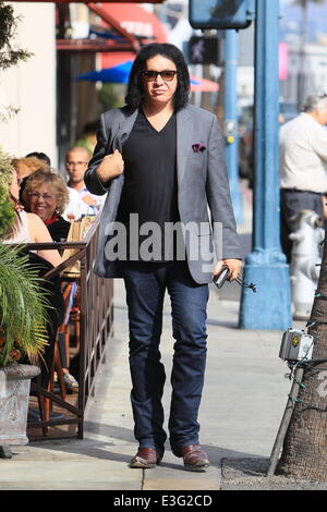 Gene Simmons seen leaving Panini Cafe in Beverly Hills. He goes to his car to show the photographers an award he was recently given, The Charles Durning Award. Gene then poses for a picture with a young fan and gives the fan his sunglasses for the shot. Stock Photo