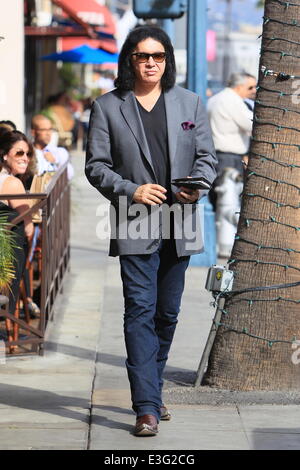 Gene Simmons seen leaving Panini Cafe in Beverly Hills. He goes to his car to show the photographers an award he was recently given, The Charles Durning Award. Gene then poses for a picture with a young fan and gives the fan his sunglasses for the shot. Stock Photo