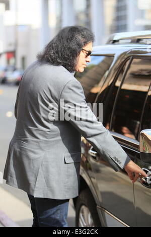 Gene Simmons seen leaving Panini Cafe in Beverly Hills. He goes to his car to show the photographers an award he was recently given, The Charles Durning Award. Gene then poses for a picture with a young fan and gives the fan his sunglasses for the shot. Stock Photo