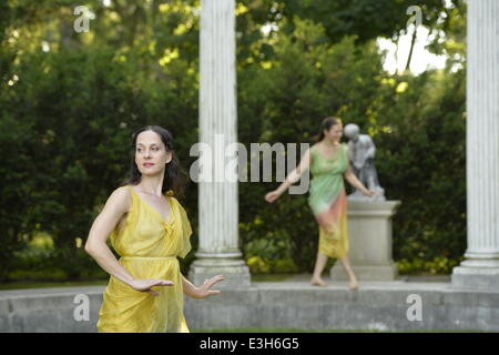 Old Westbury, New York, U.S. - June 21, 2014 - Dancers in colorful Greek tunics appear at the Colonnade when Lori Belilove & The Isadora Duncan Dance Company starts to dance throughout the gardens, at the Long Island Gold Coast estate of Old Westbury Gardens on the first day of summer, the summer solstice. Stock Photo