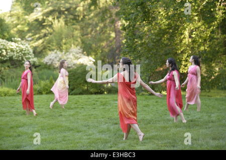 Old Westbury, New York, U.S. - June 21, 2014 - Lori Belilove & The Isadora Duncan Dance Company dances in Greek tunics throughout the gardens during the Midsummer Night event at the Long Island Gold Coast estate of Old Westbury Gardens on the first day of summer, the summer solstice. Stock Photo