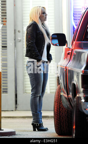 Britney Spears filming the promo for her new single 'Perfume' in Lancaster, California. The pop star films a scene kissing and cuddling with her co-star Alexander Kjellevik on a roof top of an old gas station, who also showers the singer with money.  Feat Stock Photo