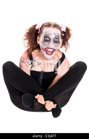 insane female clown in front of white looks to the viewer Stock Photo