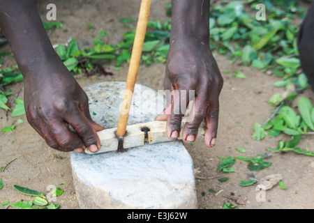 Africa, Tanzania, Lake Eyasi, Hadza men light camp fire by rubbing two sticks together. Stock Photo