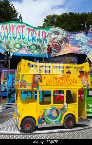 Children's roundabout and Ghost Train at Sefton Park, Liverpool, UK Stock Photo