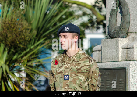 Young soldier standing by a war memorial England UK Stock Photo