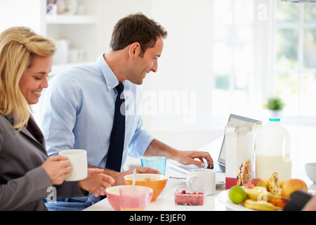 Couple Having Breakfast Together Before Leaving For Work Stock Photo