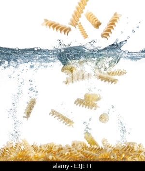 falls uncooked pasta in boiling water Stock Photo