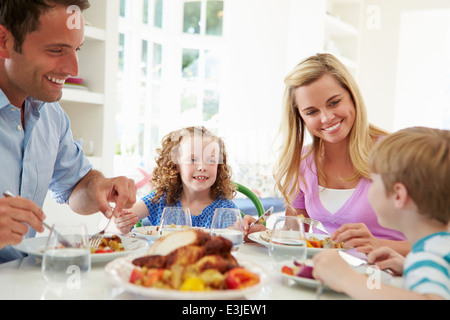 Family Eating Meal At Home Together Stock Photo