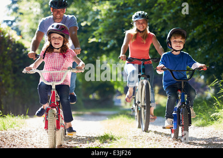 Family On Cycle Ride In Countryside Stock Photo