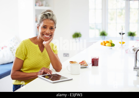 African American Woman Using Digital Tablet At Home Stock Photo