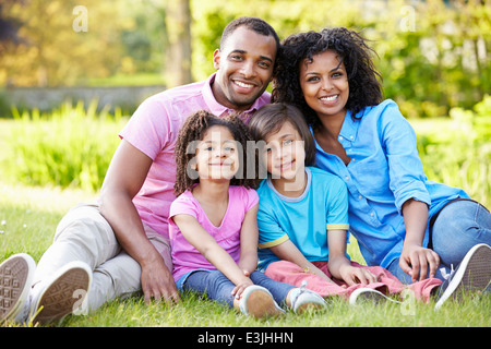 African American Family Sitting In Garden Stock Photo