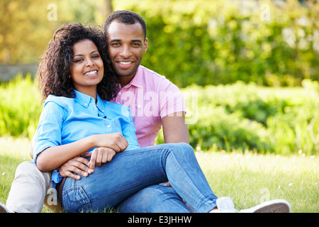 Romantic Young Couple Sitting In Garden Stock Photo