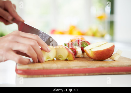 Close Up Of Woman Preparing Fruit Salad Stock Photo