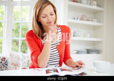 Woman Relaxing With Magazine At Home Stock Photo